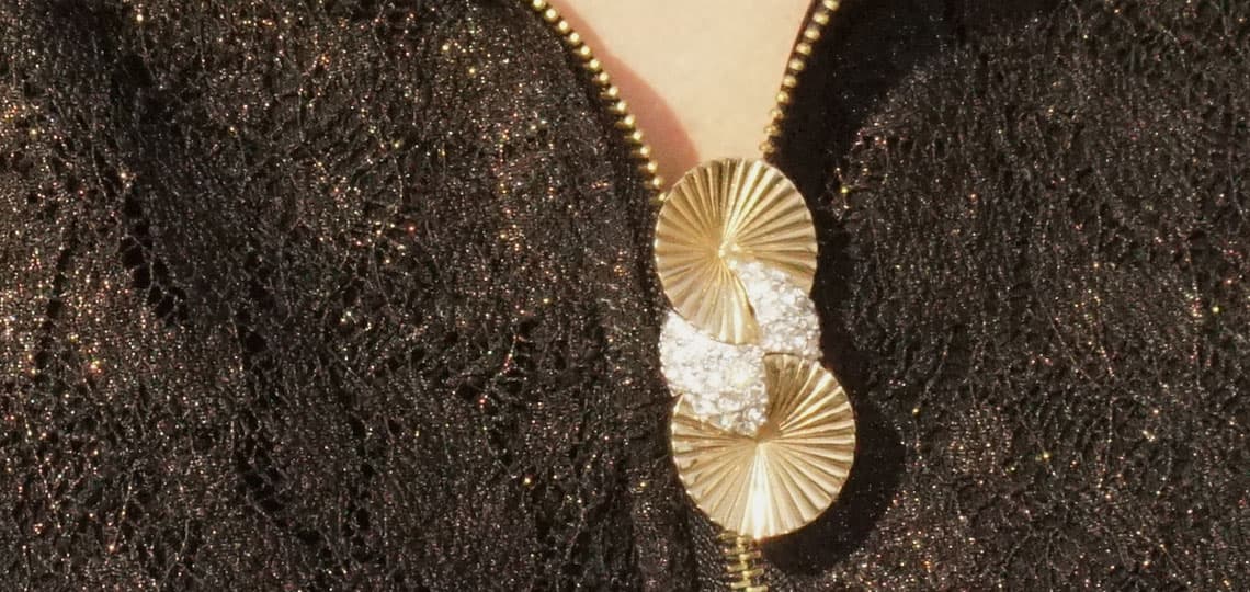 Pennino gold and diamante disc brooch attached to a zipper pull a fresh way to wear vintage for the holidays