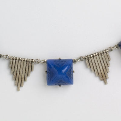 Close-up view of lapis-glass stone & silver-tone triangles