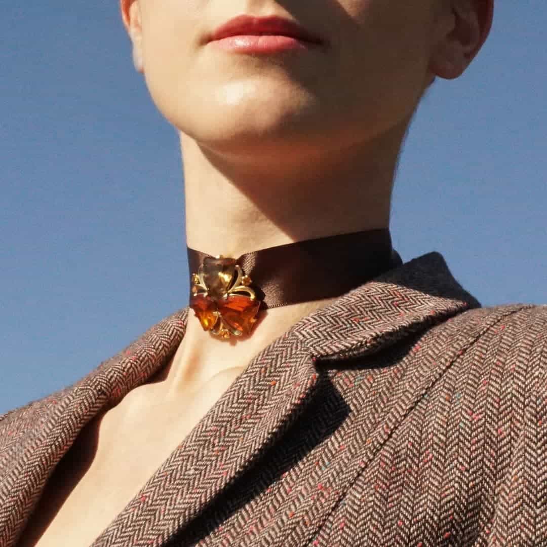 Schiaparelli topaz clover earring worn on satin ribbon choker