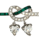 Faux emerald & diamante love knot w/dangling hearts