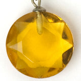 Close-up view of round, faceted drop