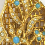Close-up view of layered, jeweled brooch