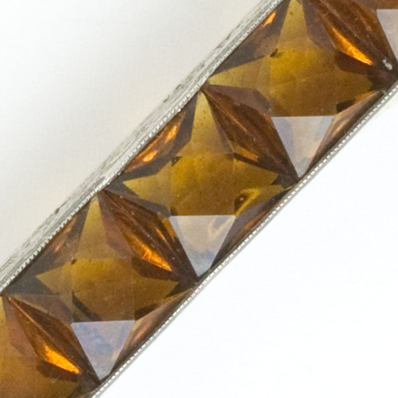 Close-up view of faceted channel-set stones
