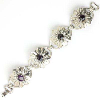 Four sterling flowers with amethyst centers